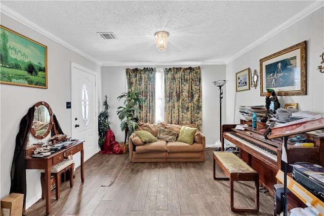 sitting room featuring ornamental molding, a textured ceiling, and light hardwood / wood-style flooring