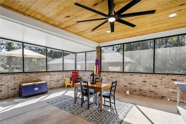 sunroom with ceiling fan, plenty of natural light, and wooden ceiling