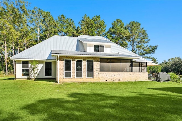 back of property featuring a lawn