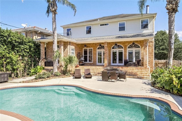 back of property with a patio and french doors