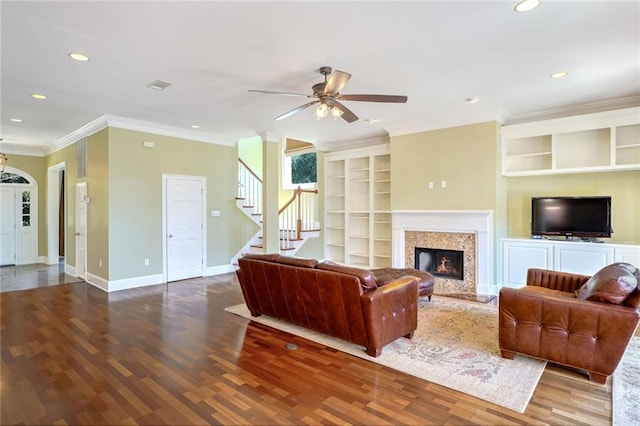 living room with crown molding, hardwood / wood-style floors, and ceiling fan