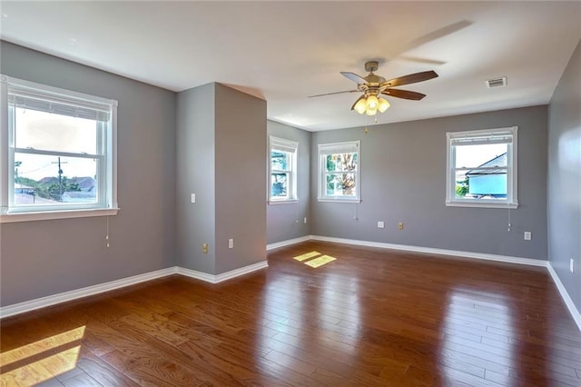 unfurnished room with ceiling fan and dark hardwood / wood-style flooring