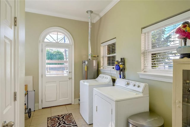 clothes washing area featuring crown molding, water heater, light tile patterned floors, and washer and clothes dryer