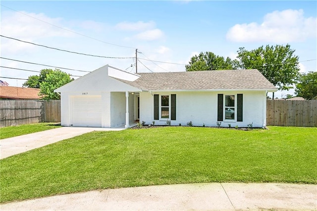 ranch-style house featuring a front yard and a garage