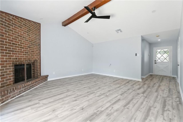 unfurnished living room with light hardwood / wood-style floors, lofted ceiling with beams, a fireplace, and ceiling fan