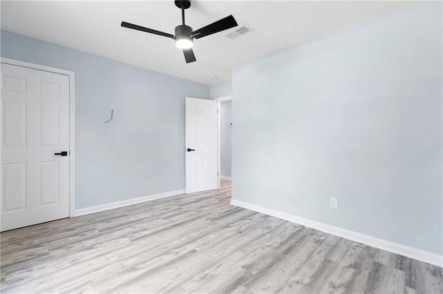 empty room featuring ceiling fan and light wood-type flooring