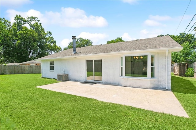 rear view of property with a patio, central AC, and a lawn