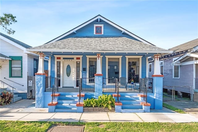 view of front facade with a porch and a carport