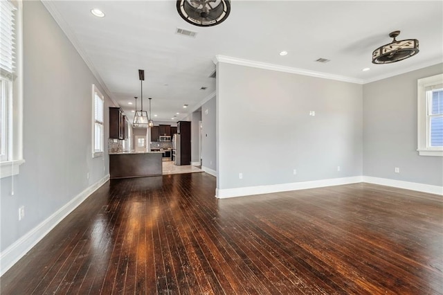 unfurnished living room with crown molding and dark wood-type flooring