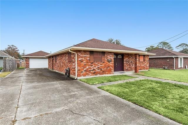 ranch-style home with a front yard and a garage