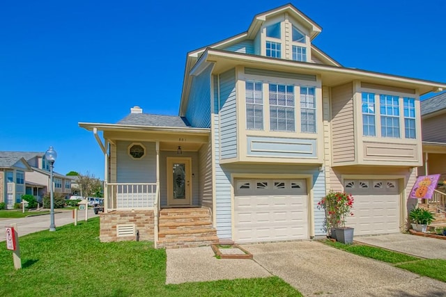 view of front of home featuring a front lawn and a garage