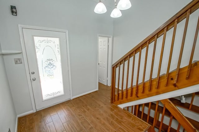 foyer entrance featuring an inviting chandelier and light hardwood / wood-style flooring