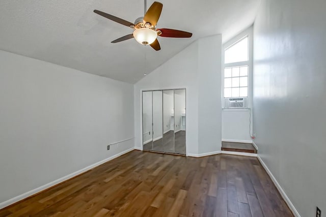 801 Audubon Trce Unit 801, Jefferson, LA 70121 - unfurnished bedroom featuring cooling unit, wood finished floors, vaulted ceiling, a closet, and ceiling fan