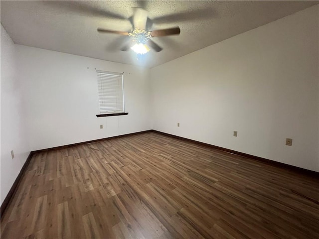 empty room featuring hardwood / wood-style flooring, ceiling fan, and a textured ceiling