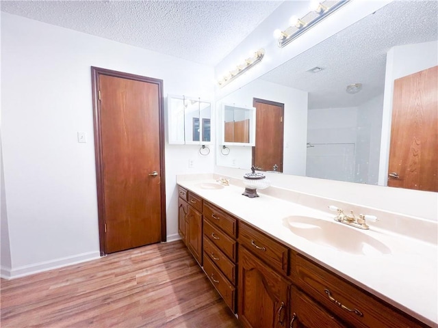 bathroom with vanity, a textured ceiling, and hardwood / wood-style flooring