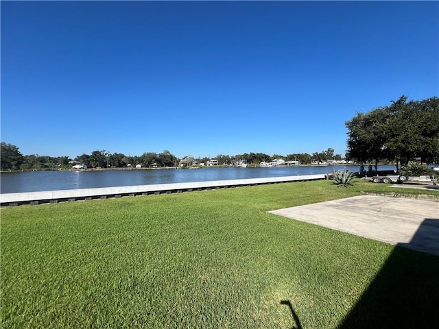 view of yard with a patio area and a water view