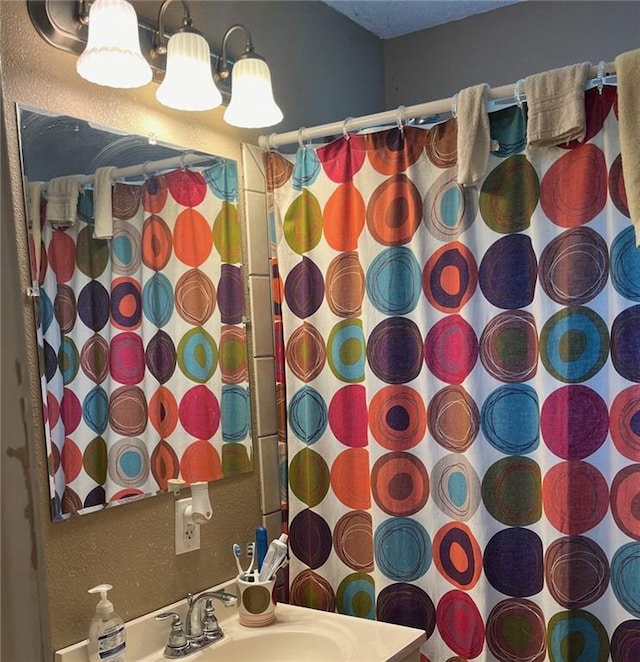 bathroom with sink and walk in shower