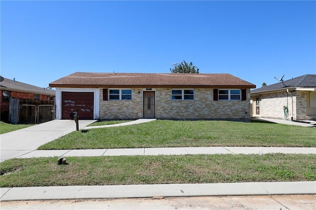 ranch-style house with a garage and a front lawn