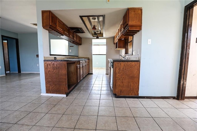 kitchen featuring stainless steel electric range and light tile patterned floors