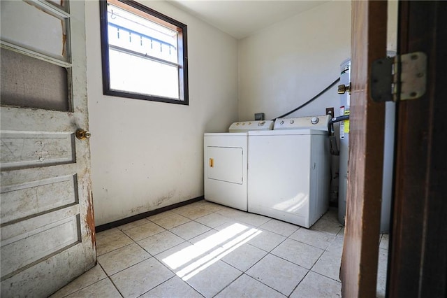 laundry room with light tile patterned flooring and washing machine and clothes dryer