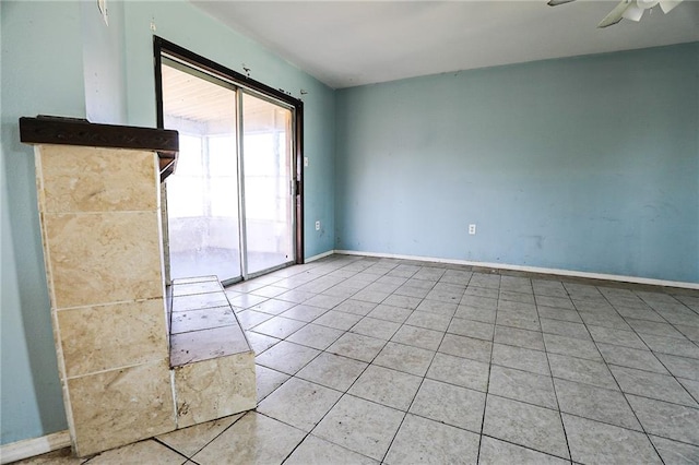 unfurnished room featuring ceiling fan and light tile patterned floors