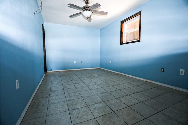 tiled empty room featuring ceiling fan