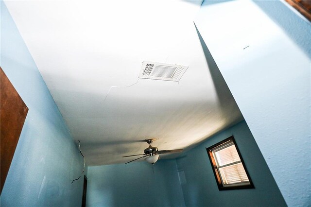 unfurnished living room featuring a fireplace, light tile patterned floors, and ceiling fan