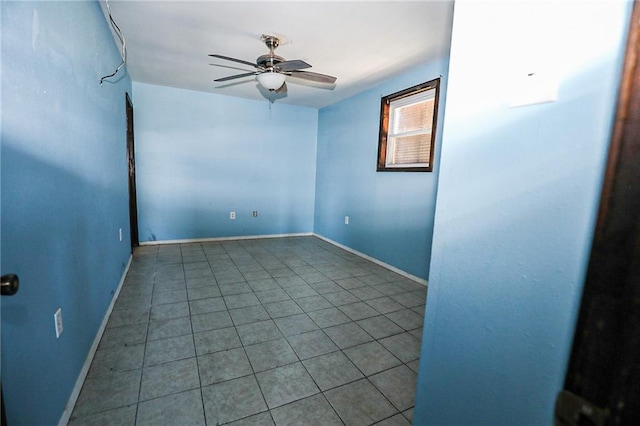 empty room with ceiling fan and tile patterned flooring