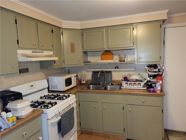 kitchen with green cabinets, crown molding, white appliances, and sink