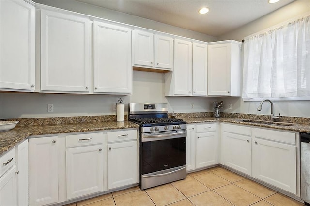 kitchen with a sink, white cabinetry, recessed lighting, stainless steel appliances, and light tile patterned floors