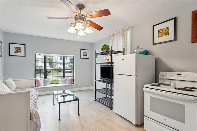 kitchen featuring ceiling fan and white appliances