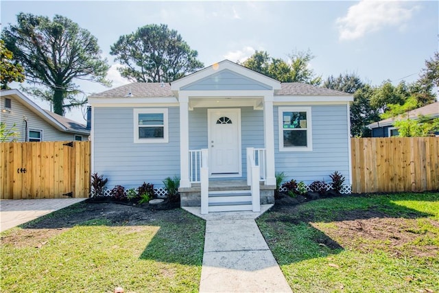 bungalow-style home featuring a front lawn