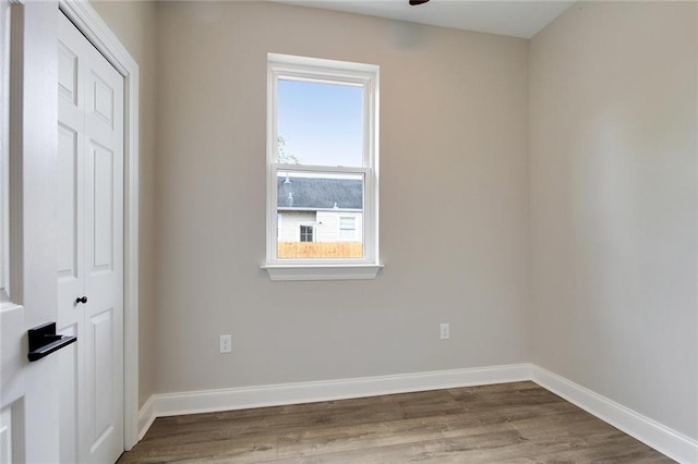 spare room with hardwood / wood-style flooring and ceiling fan