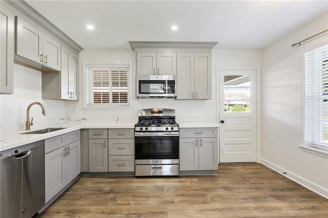 200-202 Pink St, Metairie, LA 70005 - kitchen with appliances with stainless steel finishes, a sink, gray cabinets, plenty of natural light, and recessed lighting