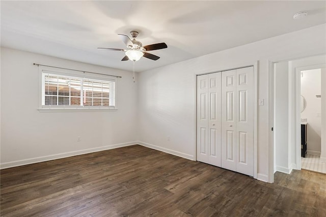 unfurnished bedroom with ceiling fan, a closet, and dark hardwood / wood-style floors