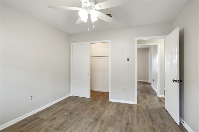 200-202 Pink St, Metairie, LA 70005 - unfurnished bedroom with a closet, wood finished floors, baseboards, and ceiling fan