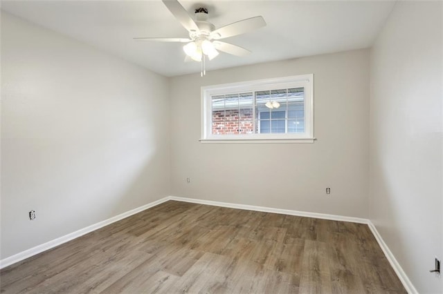 spare room with ceiling fan and hardwood / wood-style flooring