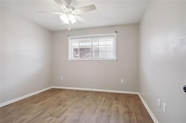 spare room with ceiling fan and light wood-type flooring