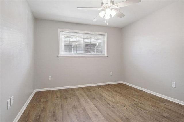 200-202 Pink St, Metairie, LA 70005 - empty room with wood finished floors, a ceiling fan, and baseboards