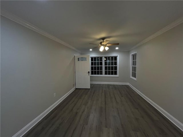 empty room featuring crown molding, ceiling fan, and dark hardwood / wood-style floors