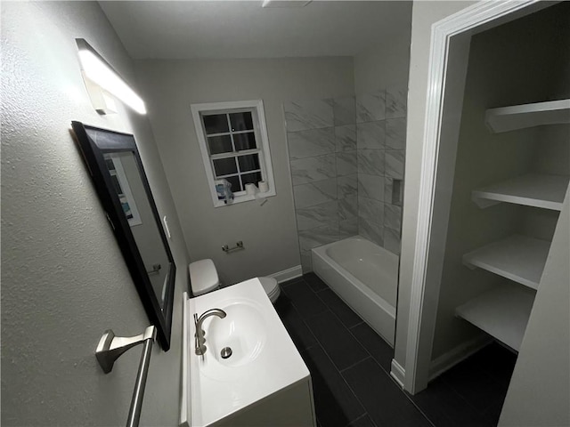 full bathroom with tiled shower / bath combo, vanity, and toilet