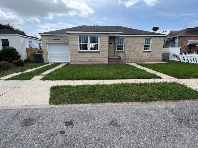 view of front of house with a garage and a front yard