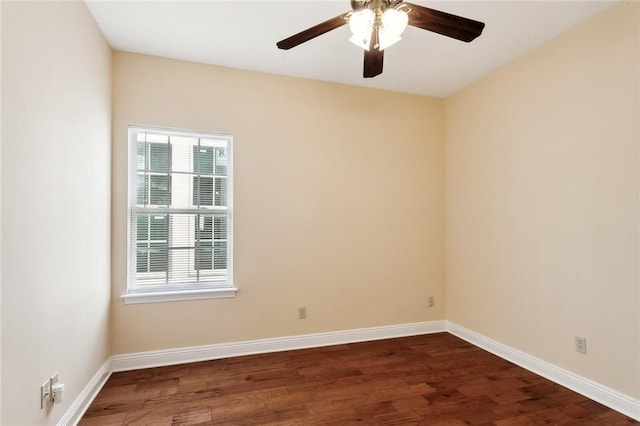 spare room with dark hardwood / wood-style floors and ceiling fan