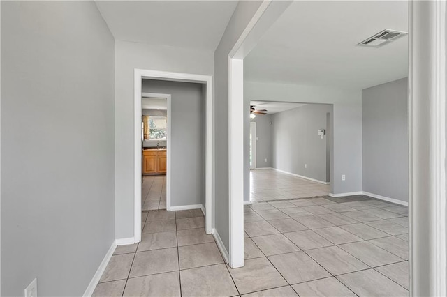 interior space with visible vents, baseboards, and light tile patterned flooring