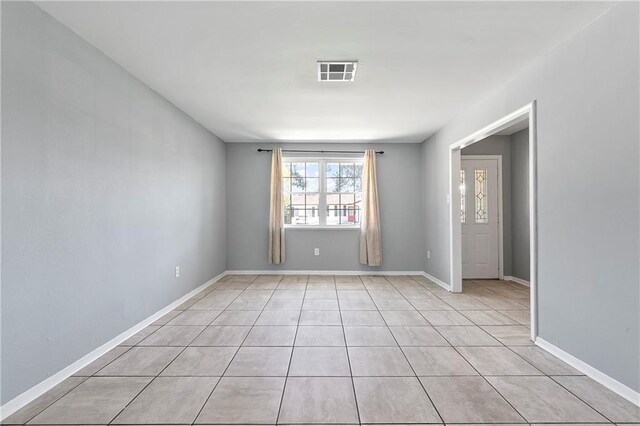 spare room featuring light tile patterned floors