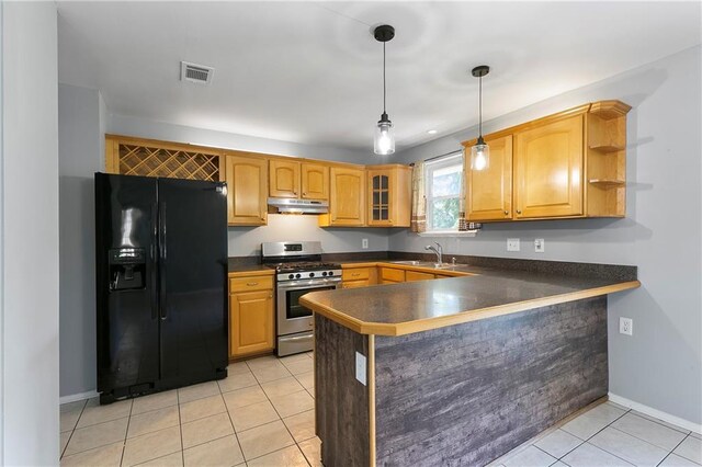 kitchen featuring light tile patterned flooring, stainless steel gas range oven, black fridge with ice dispenser, kitchen peninsula, and hanging light fixtures