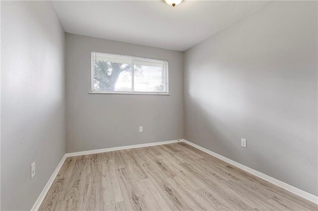 empty room with light wood-style floors and baseboards