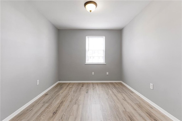 unfurnished room featuring light wood-style flooring and baseboards