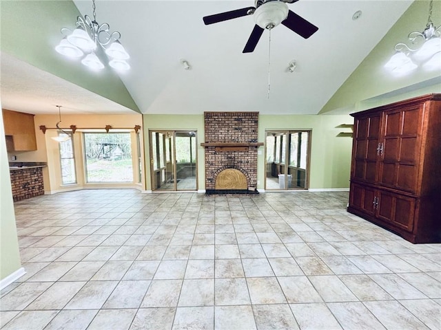 unfurnished living room featuring brick wall, ceiling fan with notable chandelier, light tile patterned flooring, and lofted ceiling