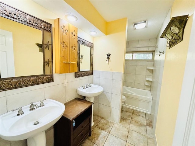 bathroom with toilet, tile walls, sink, and tile patterned floors